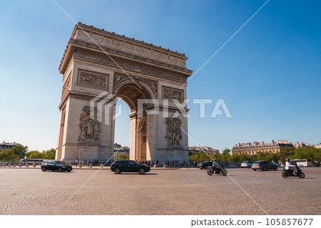 Arc de Triomphe in Paris, France under a purple sky with a cloudy weather and city landscape. 105857677