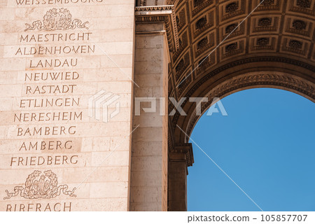 Neoclassical-style white stone Arch of Triumph in Paris, serving as a memorial with names of French generals and victories. Neoclassical-style white stone Arch of Triumph in Paris, serving as a memorial with names of French generals and victories. 105857707