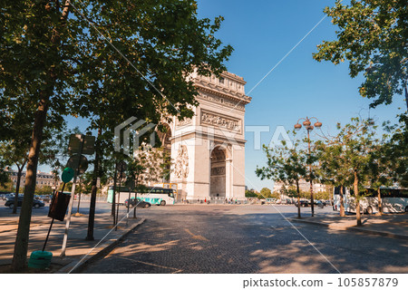 Daytime photo of the Arc de Triomphe in Paris, France under a clear sky. 105857879