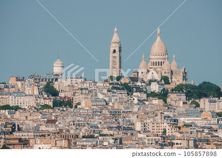 Aerial view of Paris cityscape from Sacre Coeur on a sunny summer day, with white architecture dominating. Aerial view of Paris cityscape from Sacre Coeur on a sunny summer day, with white architecture dominating. 105857898