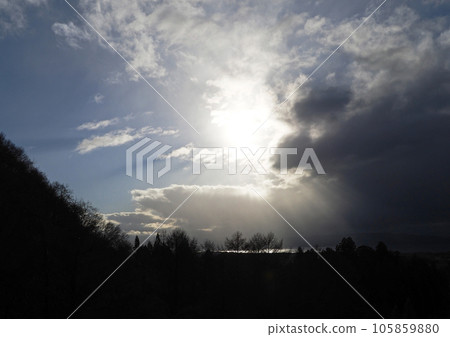 The dark clouds over Lake Inawashiro flow away, and the sun and blue sky appear. The rays of light radiating from behind the clouds are impressive and beautiful. The dark clouds over Lake Inawashiro flow away, and the sun and blue sky appear. The rays of light radiating from behind the clouds are impressive and beautiful. 105859880