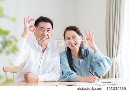 Senior couple turning on household account book Senior couple turning on household account book 105859889