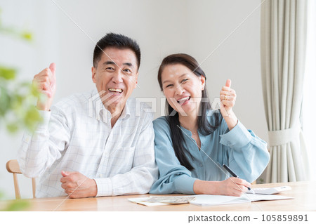 Senior couple turning on household account book Senior couple turning on household account book 105859891