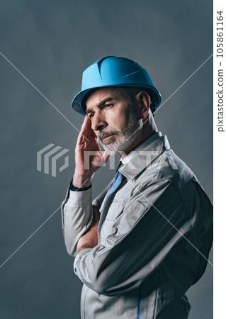A foreign man wearing work clothes to think A foreign man wearing work clothes to think 105861164