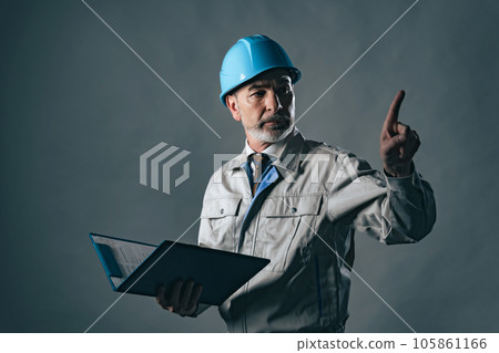 A foreign man wearing work clothes to check A foreign man wearing work clothes to check 105861166