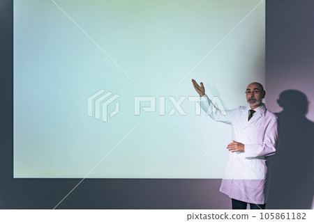 A foreign man wearing a white coat giving a presentation with a projector 105861182