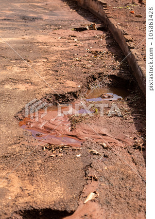 hole in asphalt street hole in asphalt street 105861428