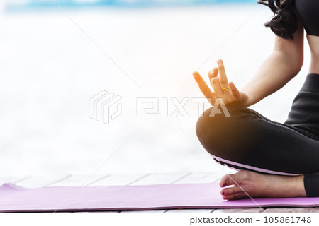 Women doing yoga hand in lotus position. Yoga fitness lifestyle healthy woman relaxation doing meditation. Yoga woman workout in sportswear sit on yoga mat home fitness workout exercise. Home fitness 105861748