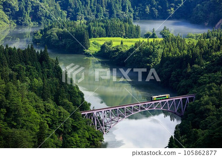 Tadami Line Kiha E120 train crossing the first Tadami River bridge in summer (Mishima Town, Fukushima Prefecture, early morning in mid-July) Tadami Line Kiha E120 train crossing the first Tadami River bridge in summer (Mishima Town, Fukushima Prefecture, early morning in mid-July) 105862877