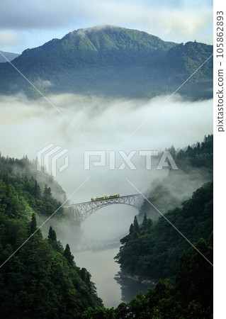 Tadami Line Kiha E120 series train crossing the first Tadami River bridge in the morning mist (Mishima Town, Fukushima Prefecture, late July) Tadami Line Kiha E120 series train crossing the first Tadami River bridge in the morning mist (Mishima Town, Fukushima Prefecture, late July) 105862893