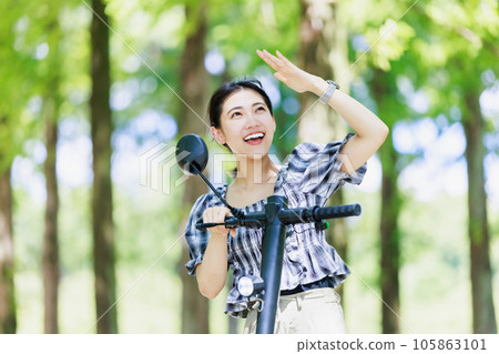A young woman riding an electric kickboard in the sun 105863101