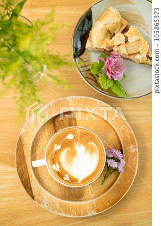 Latte art coffee on wooden background, Hot drink, Table top view Latte art coffee on wooden background, Hot drink, Table top view 105865373