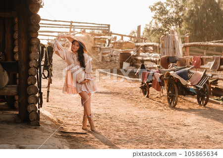 pregnant woman in a dress and hat in the countryside 105865634