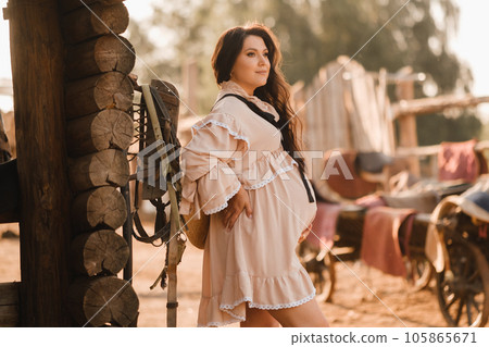 pregnant woman in a dress in the countryside pregnant woman in a dress in the countryside 105865671