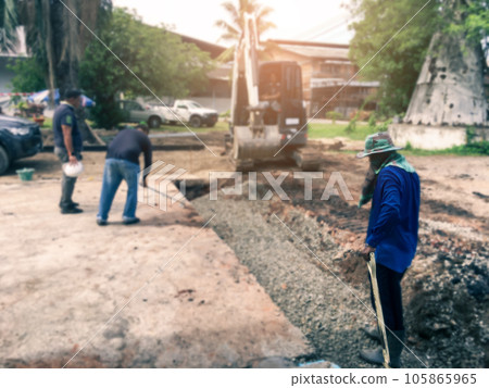 Construction and engineer worker steering a backhoe to renovate the site 105865965