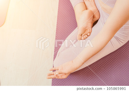 young sporty woman, fitness instructor in pink sportswear doing stretching and pilates on yoga mat in the studio with mirror. Female fitness yoga routine concept. Healthy lifestyle and harmony. young sporty woman, fitness instructor in pink sportswear doing stretching and pilates on yoga mat in the studio with mirror. Female fitness yoga routine concept. Healthy lifestyle and harmony. 105865991