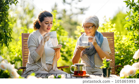 women drinking tea in the garden women drinking tea in the garden 105865993