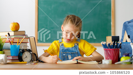 Thinking child is sitting at desk 105866520