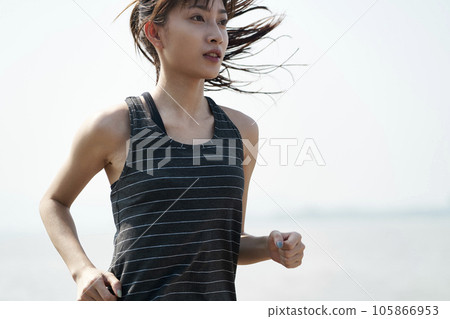 young asian woman jogging outdoors by the sea young asian woman jogging outdoors by the sea 105866953