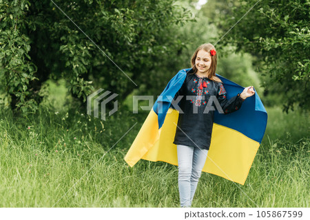 Ukraines Independence Flag Day. Constitution day. Ukrainian child girl in embroidered shirt vyshyvanka with yellow and blue flag of Ukraine in field. flag symbols of Ukraine. Kyiv, Kiev day 105867599