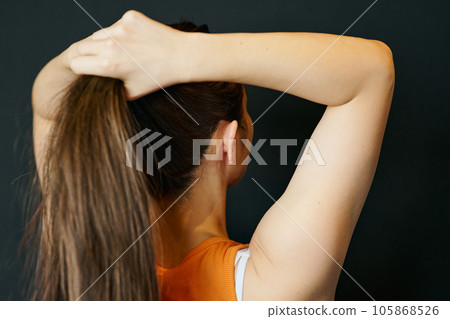 A woman in sportswear with her hair tied up 105868526
