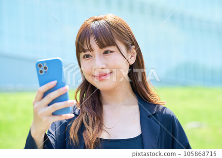 Young woman looking at smartphone screen 105868715