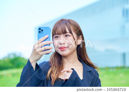 Young woman looking at smartphone screen Young woman looking at smartphone screen 105868728