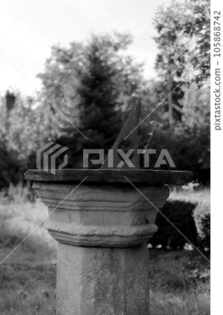 Very old sundial shows time in dense vegetation forest Very old sundial shows time in dense vegetation forest 105868742