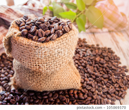 Roasted coffee beans in burlap sack Roasted coffee beans in burlap sack 105869370