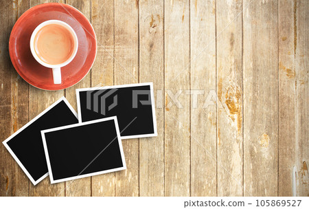 Vintage film camera and two blank photo frames on wooden table 105869527