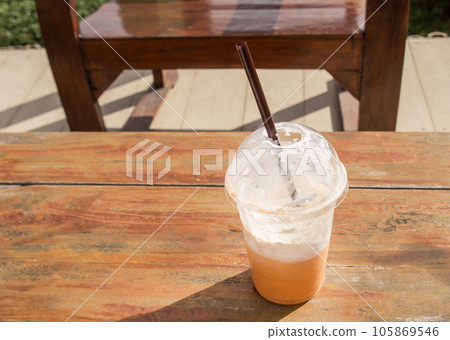Ice coffee on a wooden table Ice coffee on a wooden table 105869546