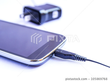 Close up black smartphone and USB cable on white background Close up black smartphone and USB cable on white background 105869768