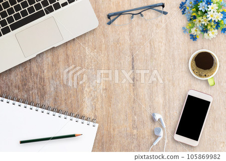 Office desk with office supplies on brown wood background Office desk with office supplies on brown wood background 105869982
