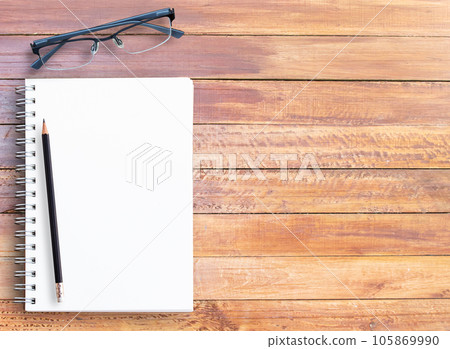 Top view of wooden table with office supplies Top view of wooden table with office supplies 105869990