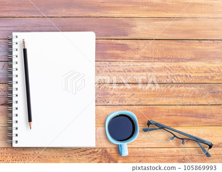 Top view of wooden table with office supplies 105869993