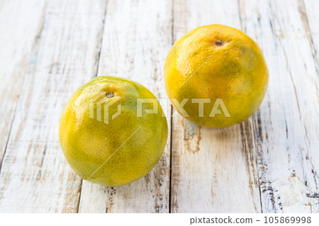 Tangerines on white wooden table background Tangerines on white wooden table background 105869998