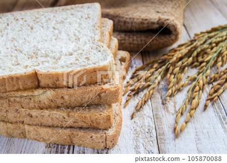 Whole wheat bread on wooden table background 105870088