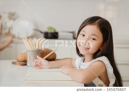 Cute child girl happy learning education doing home work at home holiday Cute child girl happy learning education doing home work at home holiday 105870807