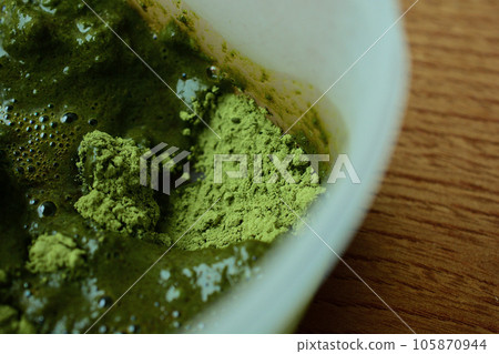 Mix henna powder for hair dye in a container with a brush Mix henna powder for hair dye in a container with a brush 105870944