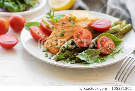 Baked Delicious salmon, green asparagus on  plate 105871863