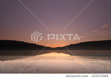 Sunrise reflected on the lake surface Sunrise reflected on the lake surface 105872068