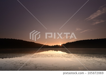 Sunrise reflected on the lake surface Sunrise reflected on the lake surface 105872069