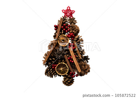 Isolated Christmas tree made from natural cones on colored background, view from above. New Year minimal concept with copy space Isolated Christmas tree made from natural cones on colored background, view from above. New Year minimal concept with copy space 105872522