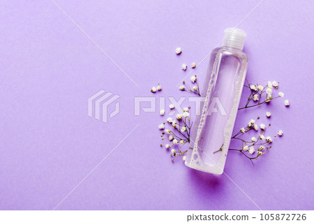 Fancy healthcare bottles for serum, micellar, tonic, toner, lotion, water and cream with gypsophila branch. Natural oranic spa cosmetics concept. Mockup, template, Top view 105872726