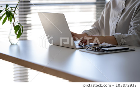 Woman working from home PC 105872932