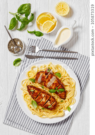 crusted chicken over lemon butter pasta, top view 105873319