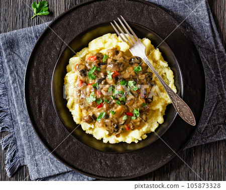 potato mash topped with mushroom gravy in bowl 105873328