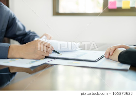 Two business leaders talk about charts, financial graphs showing results are analyzing and calculating planning strategies, business success building processes 105873623