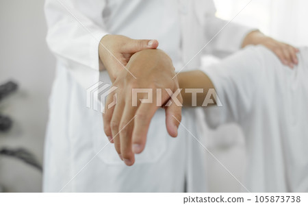 Female physiotherapists provide physical assistance to male patients with shoulder injuries massage their shoulders for muscle recovery in the rehabilitation center. Physiotherapy concepts 105873738