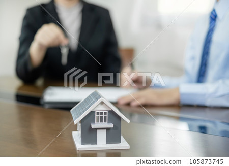 Real estate agents offer sale home insurance and close the sale immediately after the customer signs a purchase contract under a formal agreement. Real Estate Home insurance concept Real estate agents offer sale home insurance and close the sale immediately after the customer signs a purchase contract under a formal agreement. Real Estate Home insurance concept 105873745